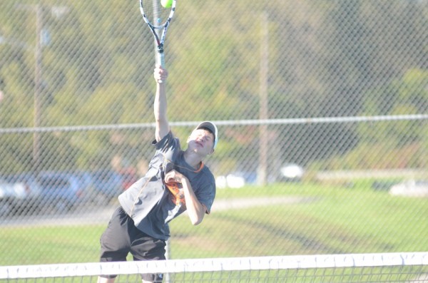 David Homme reaches for a shot for the Tigers at No. 2 doubles play Monday.