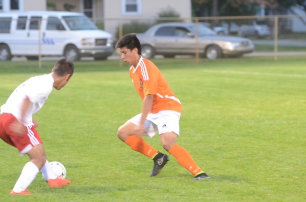 Brian Jaimes of Warsaw moves past a Goshen defender Thursday night.