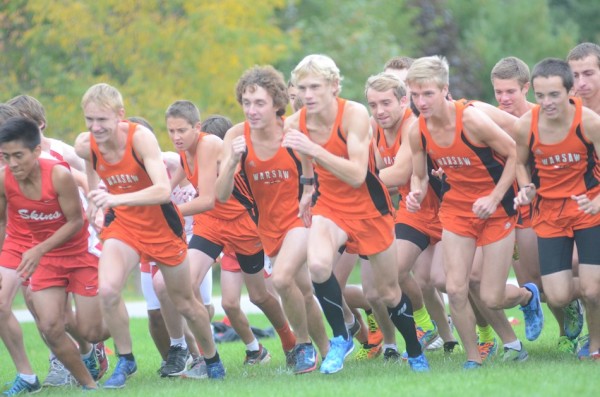 The Warsaw boys cross country team takes off at the start of the race Tuesday night in Goshen.