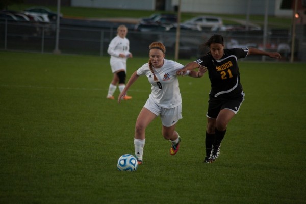 Brooklyn Jackson races the ball past a Snider defender for the Tigers.