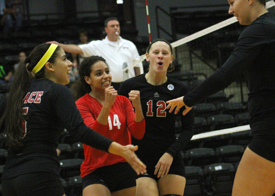 Celebrating a point during Grace's win against Bethel are Annie Salazar, Hannah Clemmons, Alix Underwood and Tori Bontrager. (Photo provided by the Grace College Sports Information Department)