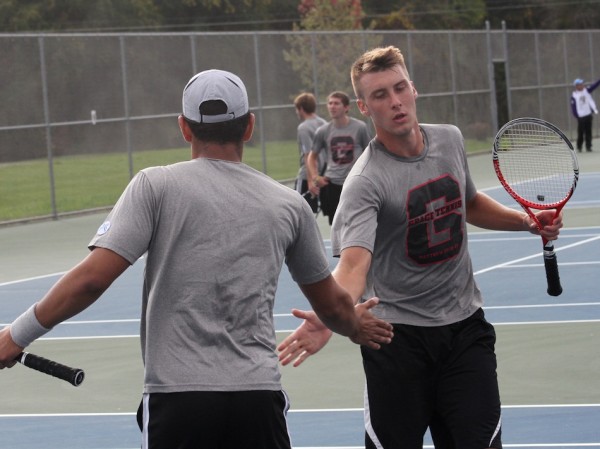 Jose Marvel (left) and Ethan Grove of Grace College celebrate a point during their No. 2 doubles match Tuesday (Photo provided by the Grace College Sports Information Department)