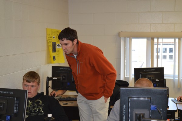  Tyler Boganwright, standing, helps student Chris Sabin in the landscaping class at Wawasee High School. Boganwright teaches landscaping and three other classes at Wawasee.