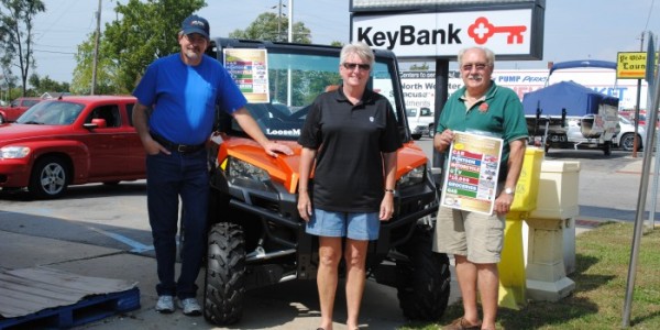 Taking a break from selling tickets to the North Webster Community Center Heart of the Community Auction and Raffle are left, Stu Coverstone, Janet Miller and Jon Sroufe. All are center board members and were in the North Webster NewMarket parking lot. One of the grand prizes, a UTV, is seen behind them. The event is from 5 p.m.-9 p.m., Saturday, at the center, 301 N. Main St. (SR 13).  (Photo by Martha Stoelting)