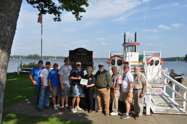 Officers of the Antique Outboard Motor Club with a certificate of appreciation for support of Dixie Sternwheeler Inc. North Webster. From the left are Jay Walls, JJ Walls, Mark Majcher, Richard White and Rick Eichrodt, all of the motor club; and Karilyn Metcalf, Bob Barnes, Jim Tranter, Russ Boucher and Dave Tranter representing theDixie. (Photo provided)