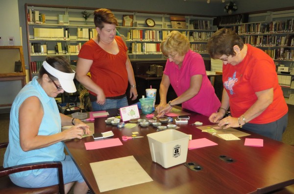  Instructor Hope Beezley (second from left) shows Pam Pollard, Sherrie Sigler and Jeri Felts how to make their own greeting cards during the Make & Take Card Class held the first Thursday each month at the library. (Photo provided)