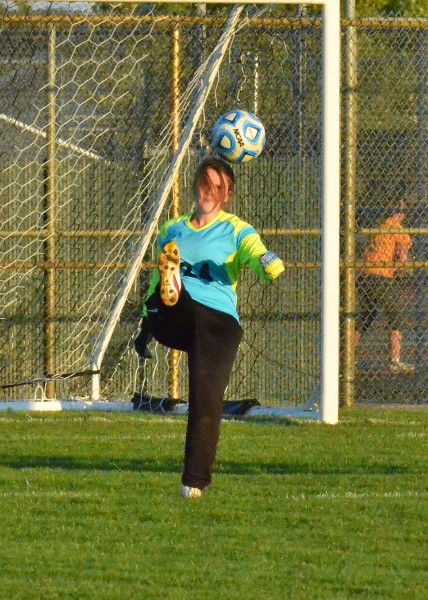 Charity Parker punts a ball after making a save in the junior varsity game for Wawasee.