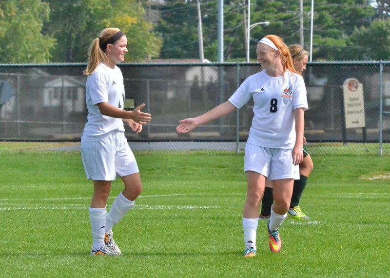 Megan Kratzsch (left) congratulates Brooklyn Jackson (right) on her first of two goals against Wawasee. (Photos by Nick Goralczyk)