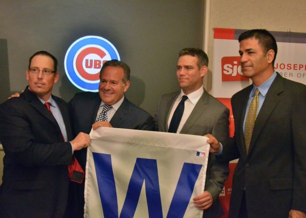 From left to right South Bend Cubs President Joe Hart, South Bend Cubs owner Andrew Berlin, Chicago Cubs President Theo Epstein and Chicago Cubs Director of Player Development Jason McLeod all pose with a 'W' flag following the press conference held at the St. Joseph's County Commerce Center. (Photos by Nick Goralczyk)