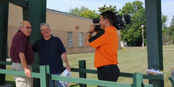 Jon Sroufe, left, shares a laugh with Gordy Young and Kelsy Zumbrun in front of the North Webster Community Center. (Photo by Martha Stoelting) 