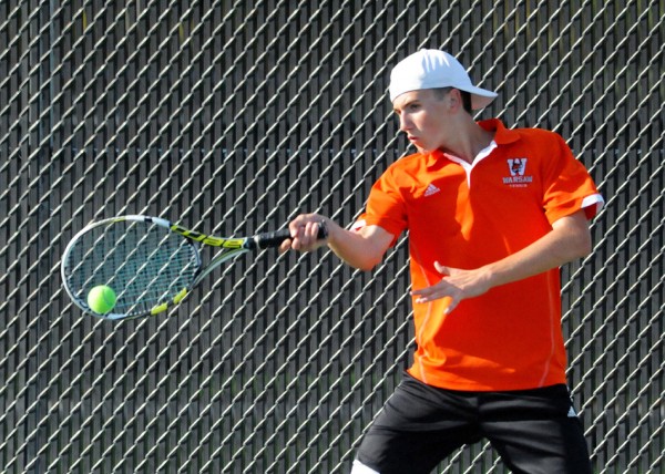 Warsaw's Cole Baker hits a shot at No. 1 doubles action  at the NLC Tourney (File photos by Mike Deak)