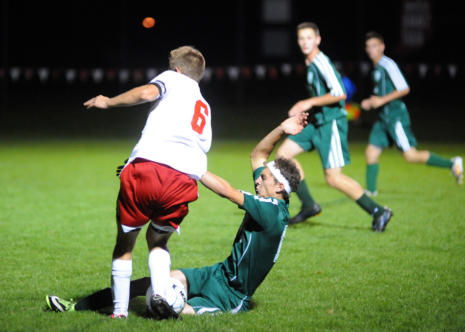 This slide tackle by Wawasee's Addison Dumford on Goshen's JT Plavchak was whistled as a penalty, which Plavchak converted for the lone goal of a 1-0 Goshen win Tuesday night. (Photos by Mike Deak)