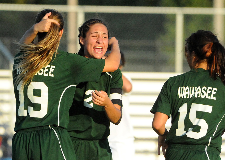 Wawasee's Sarah Lancaster celebrates with Leigh-Ann Shrack (19) and Jannette Schmidt (15) after scoring the only goal of a 1-0 win at Whitko Monday night. (Photos by Mike Deak)