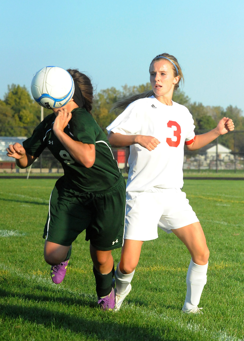 Wawasee's Alyssa Magiera takes a face full after jostling with Whitko's Reghan Craig.