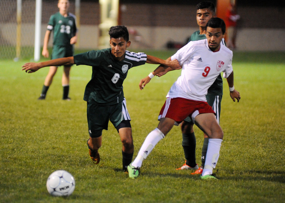 Wawasee's Ricky Camargo battles with Goshen's Kevin Garcia for possession.