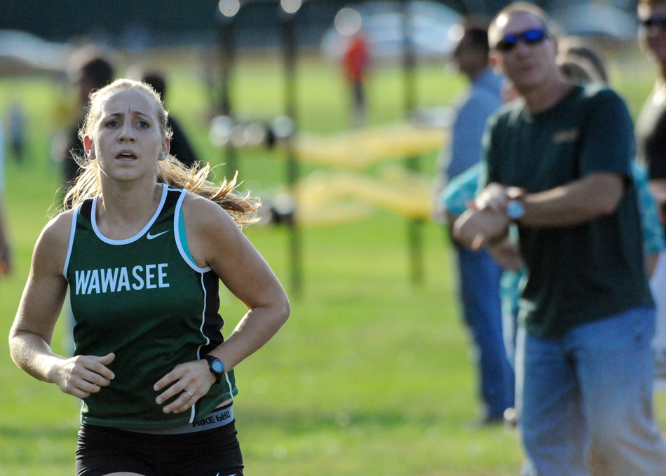 Wawasee's Sarah Harden races to the finish while dad Greg Harden keeps track of her time.