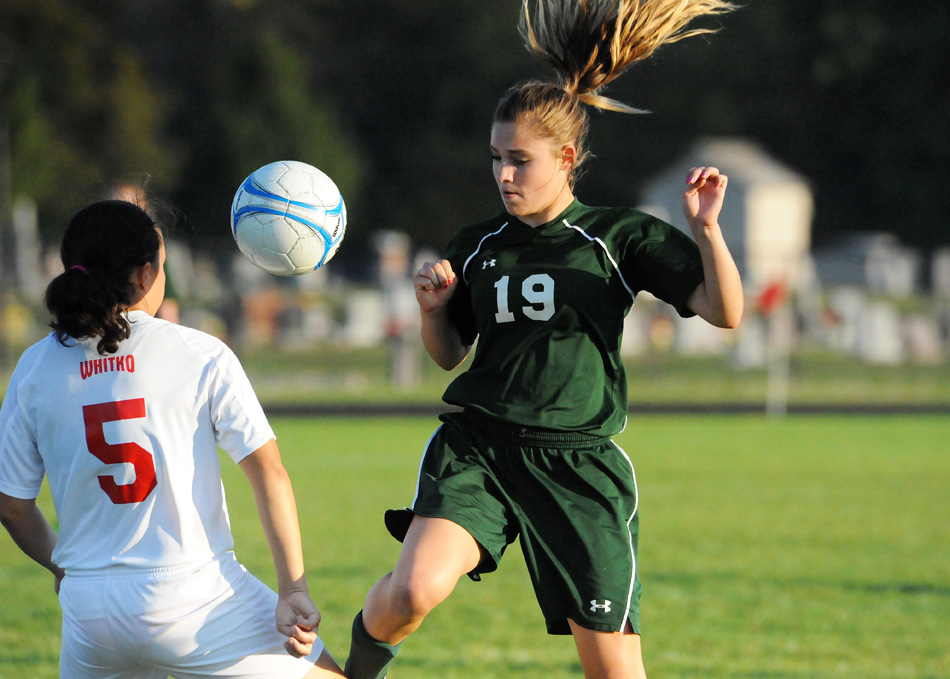 Wawasee's Leigh-Ann Shrack works for possession of the ball against Whitko's Abby Overmeyer.