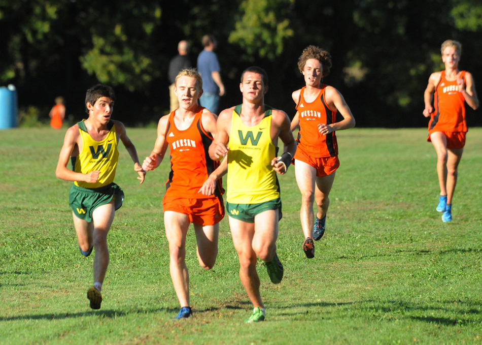 Wawasee's Troy Carolus takes a look at where Warsaw's Daniel Messenger and Wawasee's Zach Cockrill during Tuesday night's race at Wawasee. Carolus won the race at 17:18, his first-ever cross country win. (Photos by Mike Deak)
