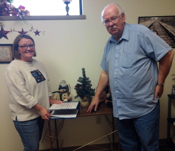 Peggy Lisenbee-Wright and Bill Leslie prepare to accept applications for the 2014 Adopt-A-Family Program at Combined Community Services. (Photo by Deb Patterson)