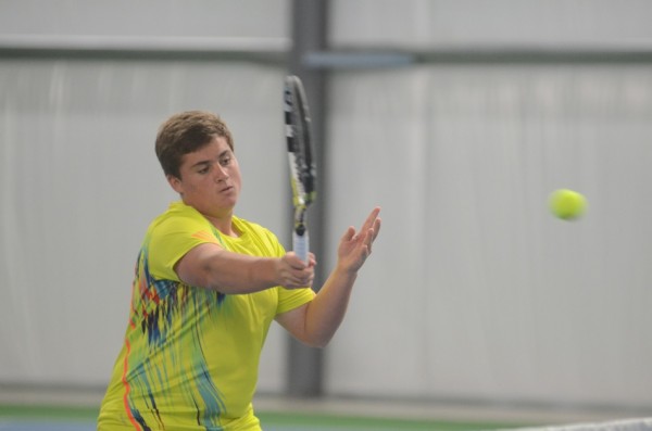 Christopher Herendeen hits a shot at the net for the Tigers in No. 1 doubles play.