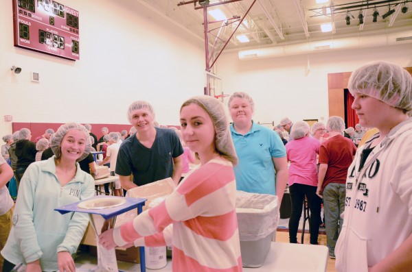 (From left) Chloe Helser, WCHS 10th grade; Hunter Haines, WCHS 10th grade; Brayden Sammons, WCHS 10th grade; Emma Manns, Edgewood Middle School eighth grade; and McKibben Lohse, Edgewood Middle School, eighth grade work to package meals as a team.  (Photo by Alyssa Richardson)