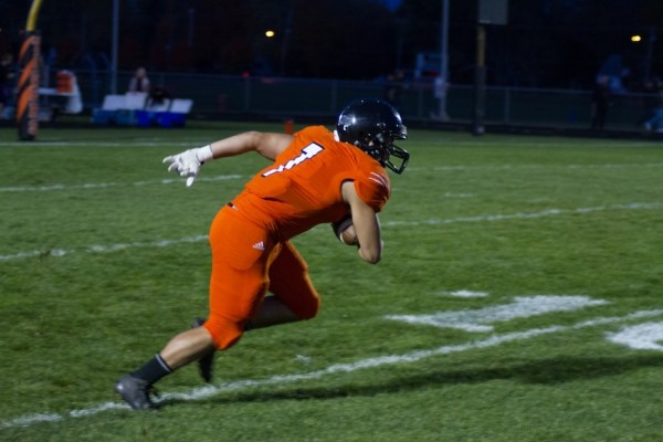 Ethyn Bradley heads up field with a kickoff return for the Tigers.