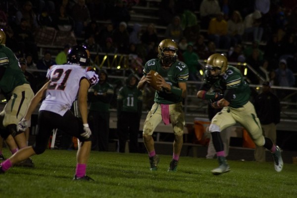 Gage Reinhard loos to pass for Wawasee Friday night. Reinhard had a huge game to help the Warriors top Warsaw 21-10 in Syracuse (Photos by Ansel Hygema)