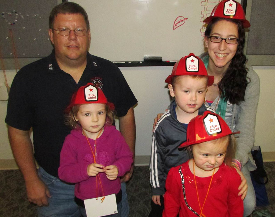 Celebrating Fire Prevention Week with volunteer fireman Brian Haines. Back Left to Right: Brian Haines and Malea Johnson. Middle Left to Right: Madeline Linville and Lukas Suranyi. In front: Lylah Young