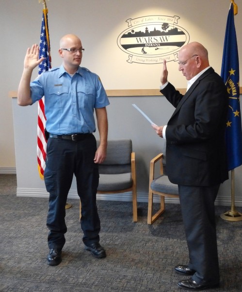 Troy Knefelkamp takes the oath of office from Charles Smith during the regular board of public works and safety meeting today.