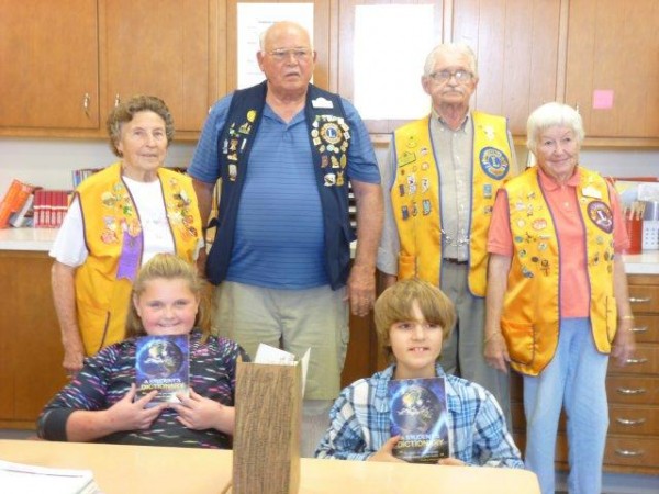 Shown with their new dictionaries are students Kylie Keirn and Orion Fancil. Lions members standing in back are Betty Rose Stahl, Bob Tenney and Mr. and Mrs. Ed Nordstrom. (Photo provided)