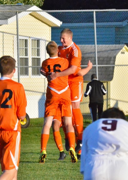 Caleb Klusman (16) celebrates with Sam Allbritten after a goal by Klusman gave Warsaw an early 1-0 lead in Monday's thrilling win over Culver Academies. (Photos by Nick Goralczyk)