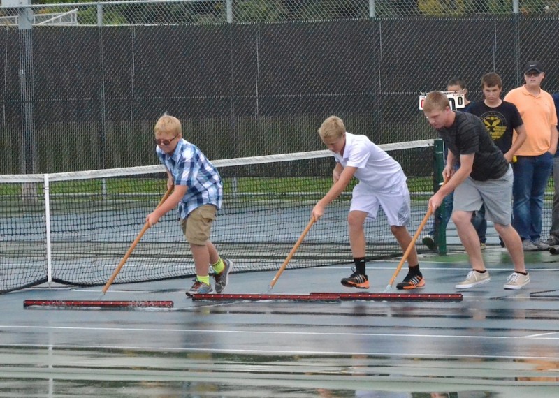Members of the Tigers junior varsity tennis team squeegee off the courts before Whitko and Warsaw took the court for the sectional title match. (Photos by Nick Goralczyk)