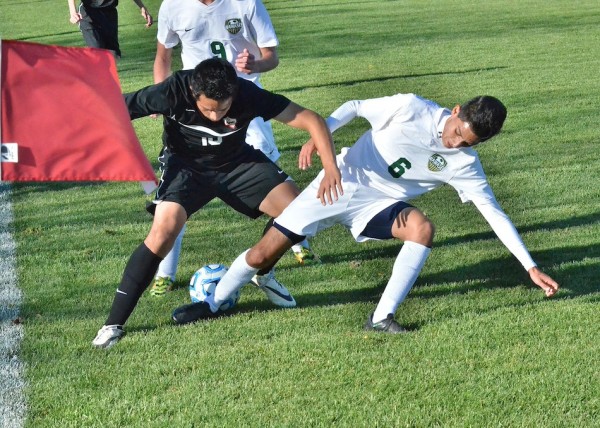 Juan Pantoja (18) of NorthWood and Ricky Camargo (6) of Wawasee fight for a ball near the corner.