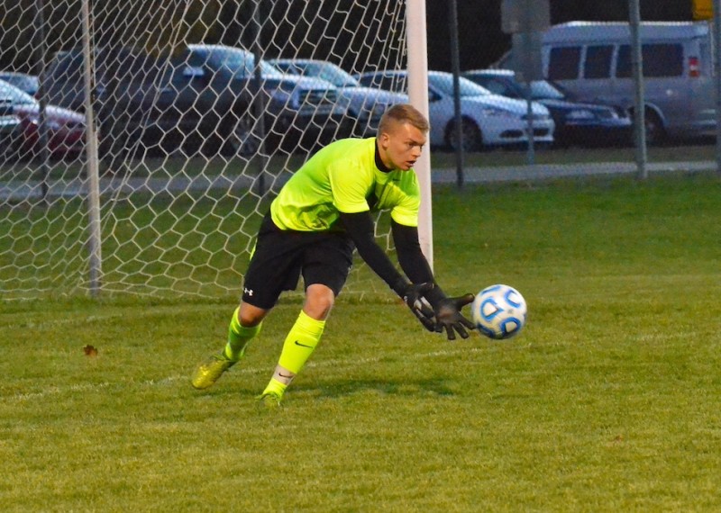 Warsaw keeper Peyton Long comes up to make a stop.