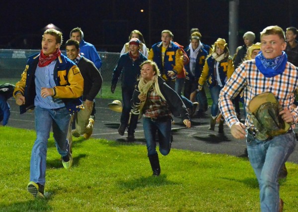Triton students storm the field to congratulate their team on winning the senior class' final home game.