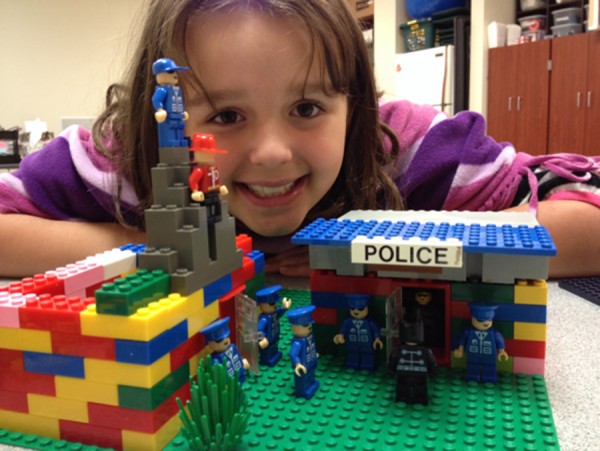 Sophie Gernand beams with pride over her LEGO police station that she built during LEGO Club.