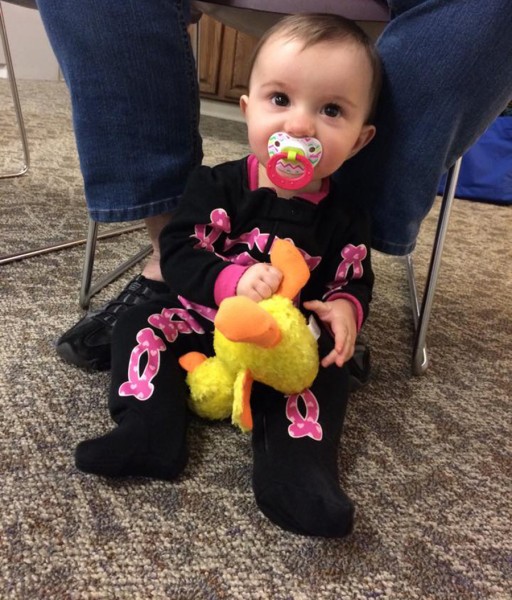 Abby Bradley plays with a stuffed animal duck at Duck Lapsit.