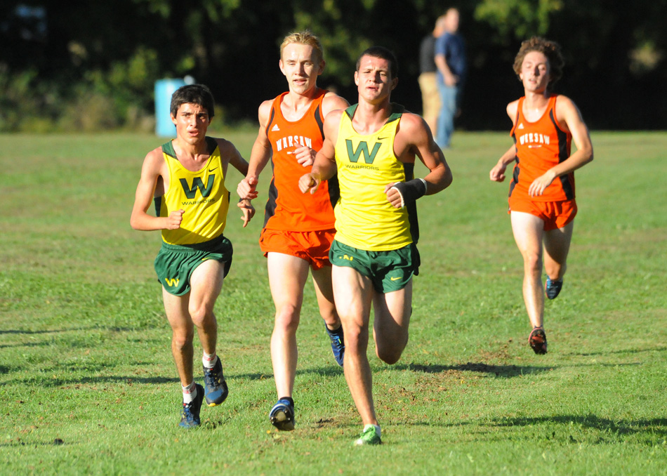 Wawasee's Troy Carolus (left) and Zach Cockrill run with Warsaw's Daniel Messenger during the NLC dual in September.