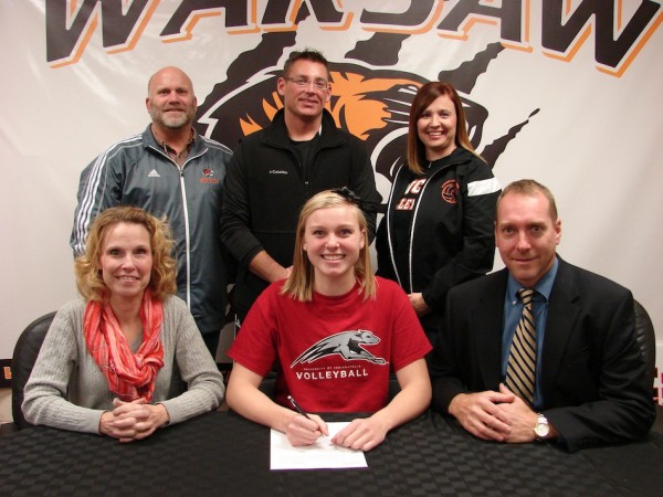 WCHS senior volleyball standout Katie Voelz signs to play at the University of Indianapolis. Voelz is shown above with her parents Gina and Brad. In back are WCHS Athletic Director Dave Anson, WCHS volleyball coach Mike Howard and WCHS volleyball assistant coach Chandra Hepler (Photo provided)