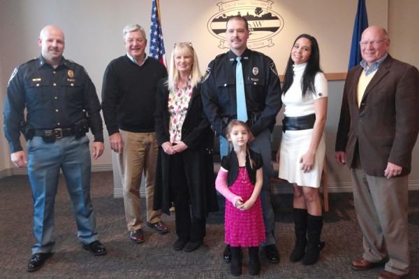 Gordon Allen III was sworn in as the newest officer with the Warsaw Police Department today. Shown are Chief Scott Whitaker, Mayor Joe Thallemer, Allen's mother Melinda Allen, Allen with daughter Aaliyah standing in front; his wife Anna Allen; and Charlie Smith, member of the board of public works and safety. (Photo by Deb Patterson)