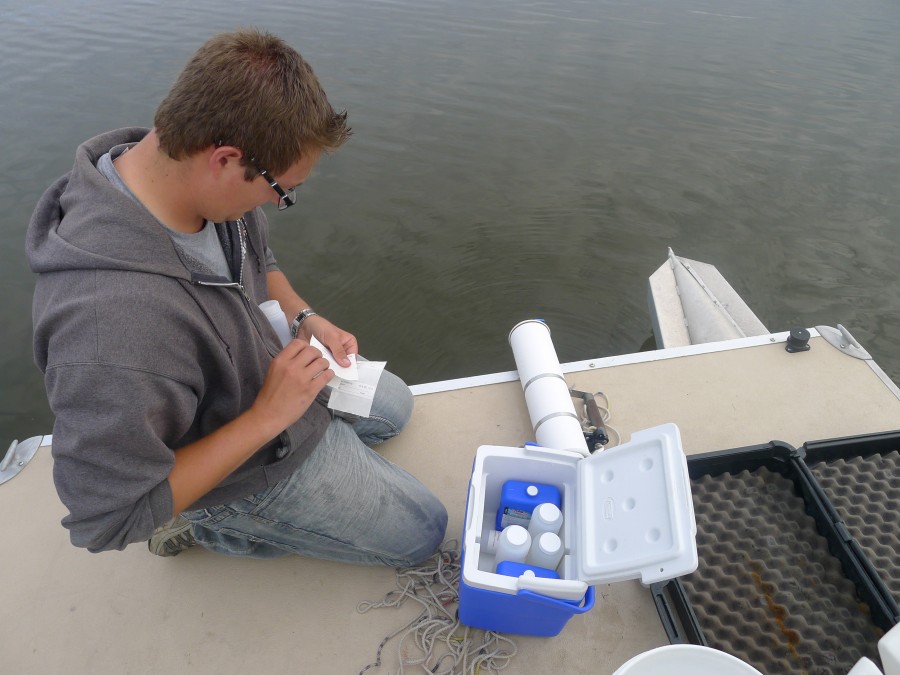 Grace College undergraduate student Logan Gilbert labels water samples from Winona Lake to be analyzed for blue-green algae and it's microcystin toxin. (Photo Provided)