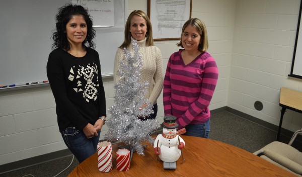 From left Steffanie Stookey, Shauna Young and Kristen Firestone of the Wawasee Middle School PTO are busy preparing for the annual craft bazaar at the school. They are shown with a few typical items to be found at the bazaar.