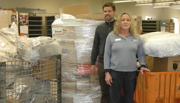 Syracuse Post Office has already seen an increase in parcels this year. Retailers have begun to push for more delivery options, according to some employees. Although most local locations will not be adding Sunday delivery, many employees will be working extra for speedy services. Pictured here are Postmaster David Bagwell (left) and USPS employee Becky Conkling.