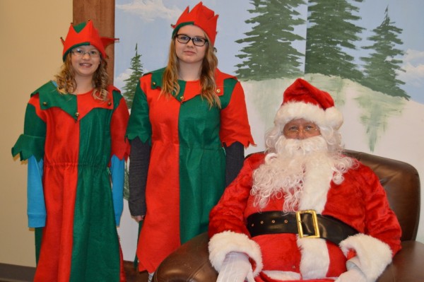 Carrie and Michelle Barth helped Santa during his visit. (Photo by Keith Knepp)