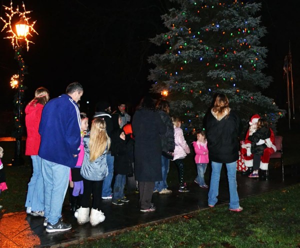 A long line of youngsters wait to tell Santa their wish list for Christmas.