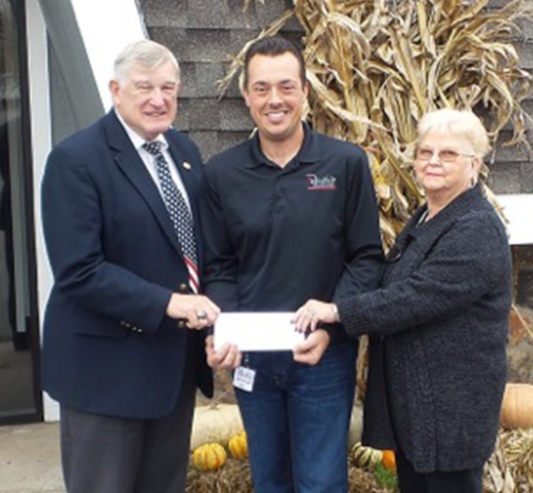 John Elliot (left) and Janice Blosser (right) present a grant check from the William and Helen Dye Endowment Fund to Fellowship Missions Director, Eric Lane (center).