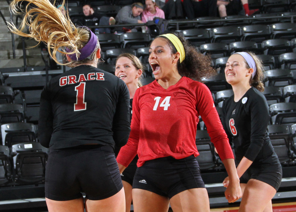 Hannah Clemmons celebrates with Calah Kruse during Grace's quarterfinal win volleyball Tuesday against Goshen. (Photo provided by the Grace College Sports Information Department)