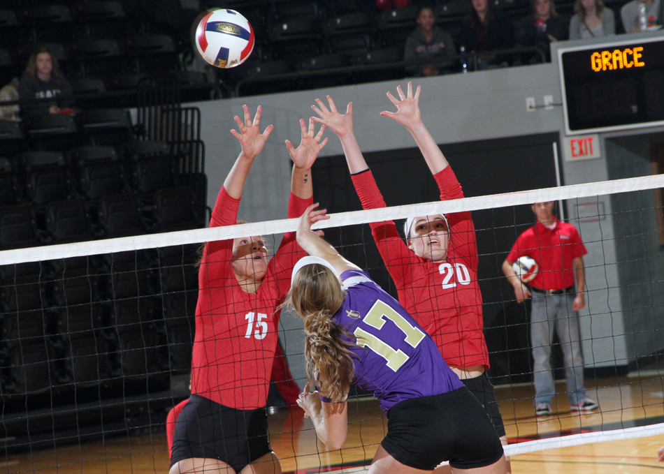 Sierra Smith (left) and Grace Woolsey attempt a block against Taylor Thursday. (Photo provided by the Grace College Sports Information Department)