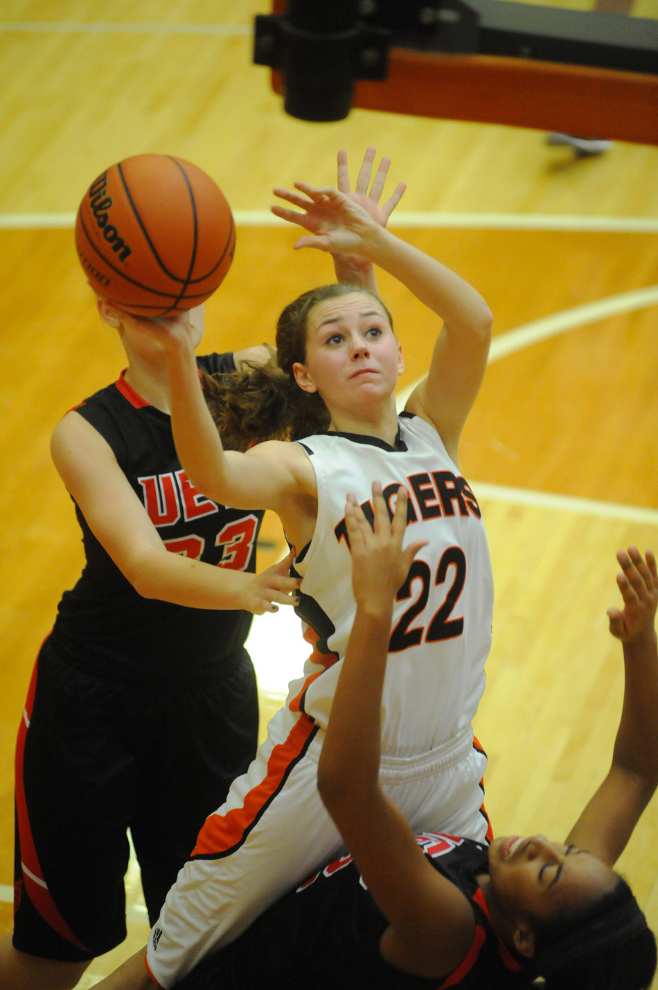 Dayton Groninger of Warsaw puts up a shot between two Fort Wayne Luers defenders.