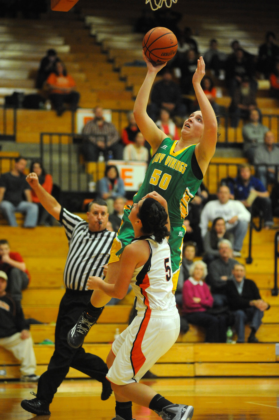 Tippecanoe Valley's Anne Secrest skies for a shot attempt over Warsaw's Page Desenberg. (Photos by Mike Deak)